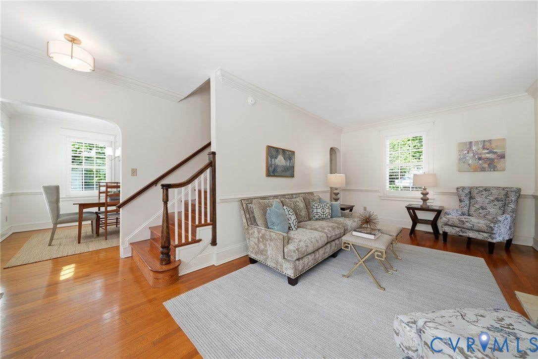 1500 Avondale Avenue, Bellevue, Richmond, VA 23227 Hardwood flooring, white wall paneling, crown molding, a built-in staircase, and a recessed archway
