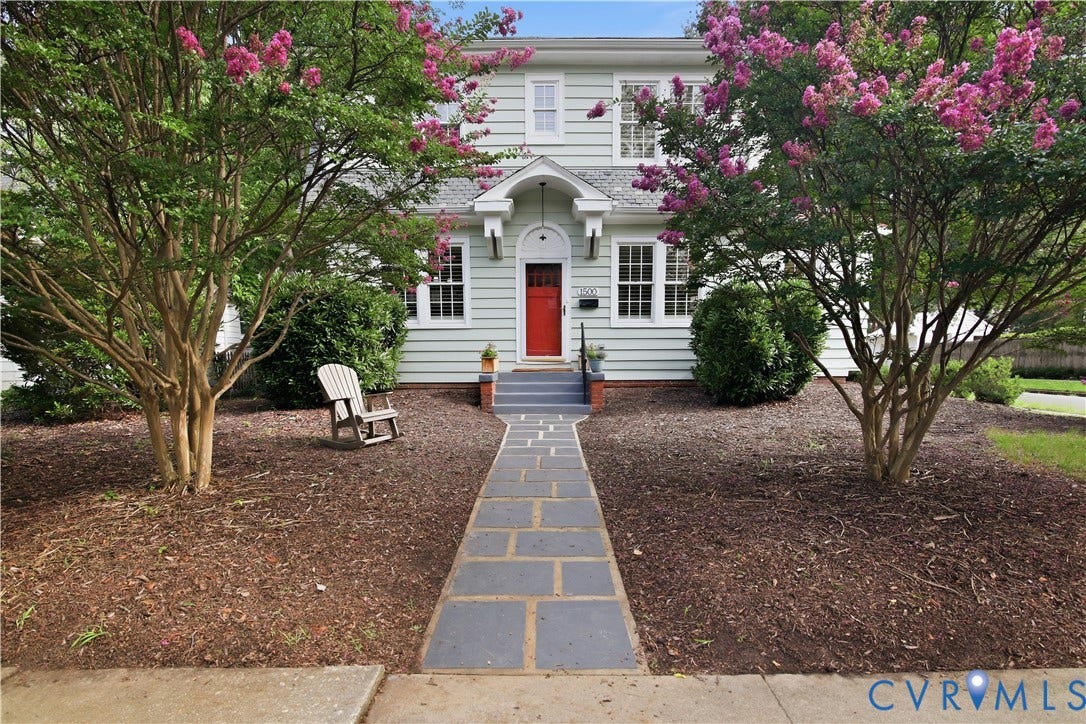 1500 Avondale Avenue, Bellevue, Richmond, VA 23227 Light blue siding exterior, red entry door, stone walkway, mature flowering trees, and established shrubs