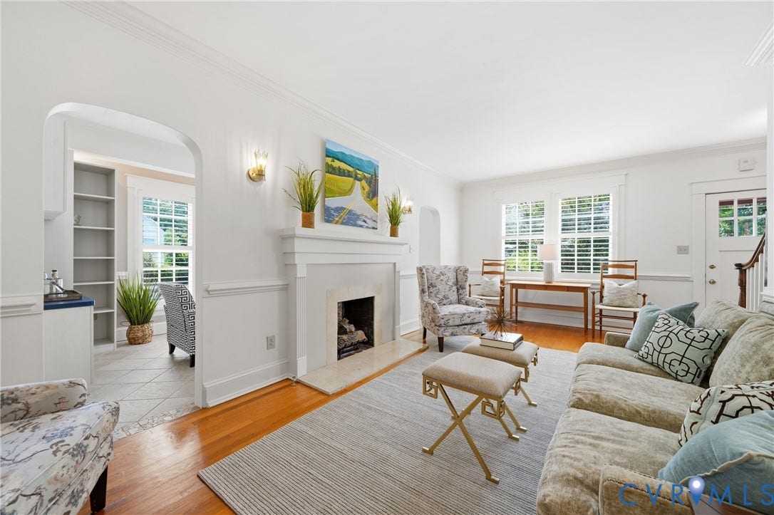 1500 Avondale Avenue, Bellevue, Richmond, VA 23227 Hardwood flooring, fireplace with mantel, arched doorway, built-in shelving, and plantation shutters