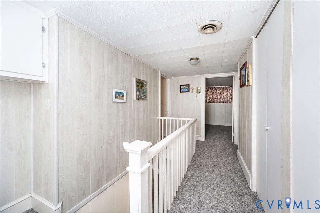 4912 Water View Road, Water View, Jamaica, VA 23180 White wood-paneling walls and a built-in white storage cabinet