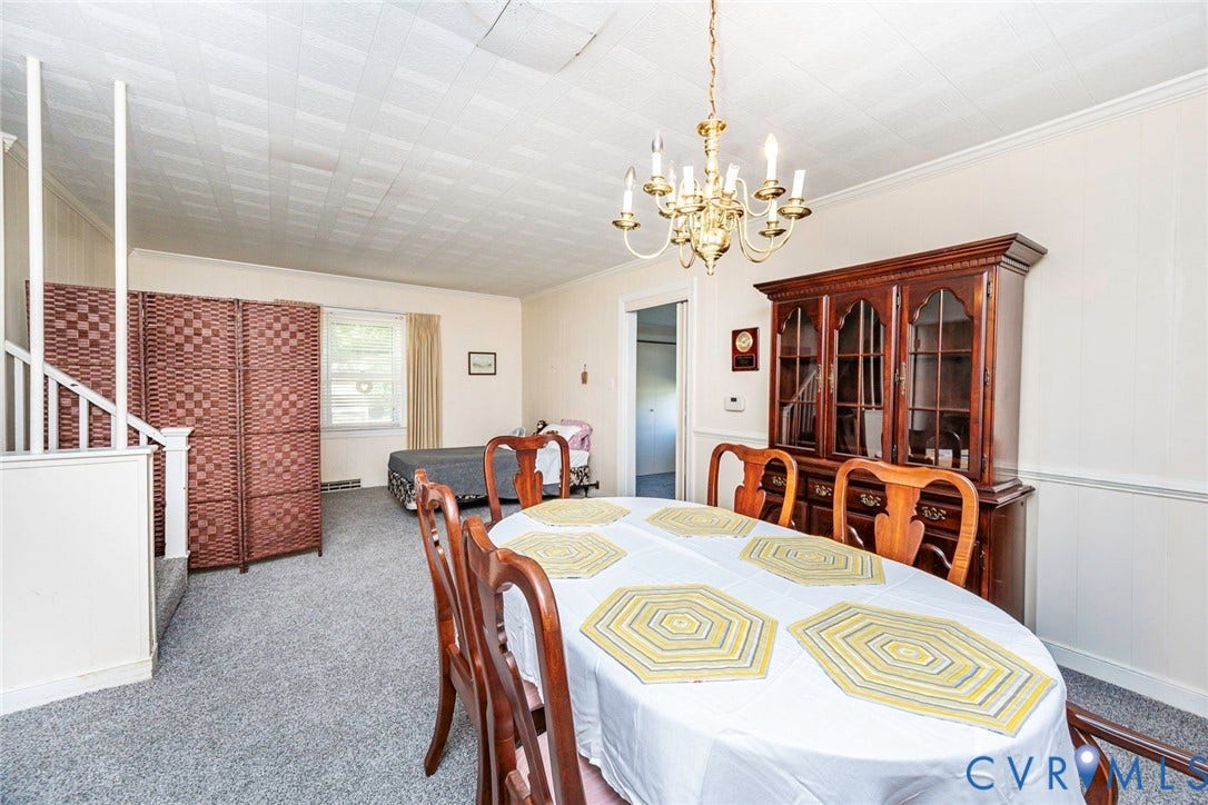 4912 Water View Road, Water View, Jamaica, VA 23180 Recessed ceiling, wainscoting, and a chandelier illuminate the dining space
