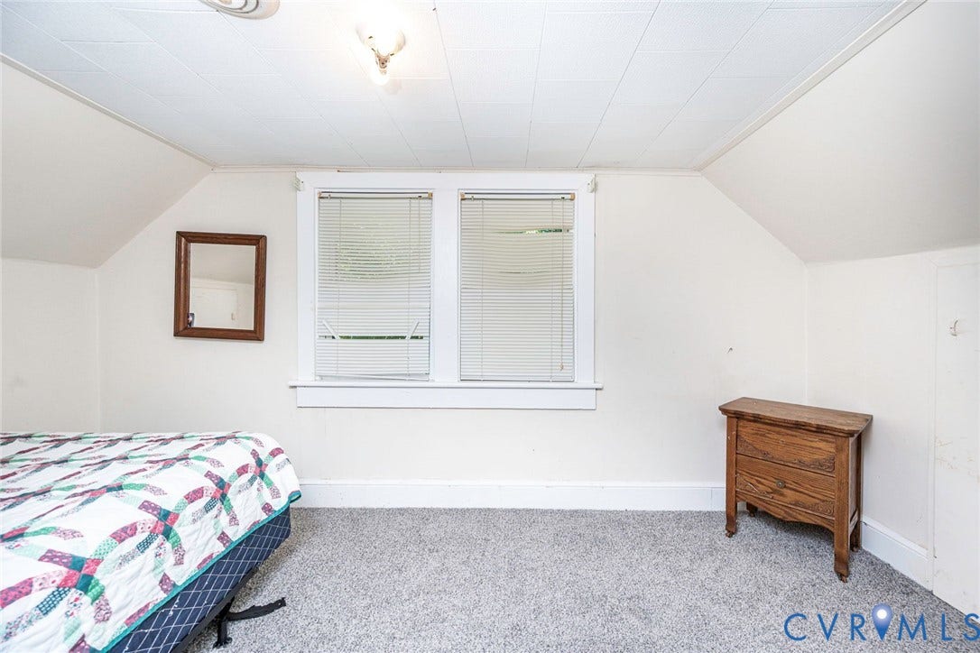 4912 Water View Road, Water View, Jamaica, VA 23180 Two window bedroom on floor 2 with white trim, vaulted ceiling, and neutral-toned carpeting