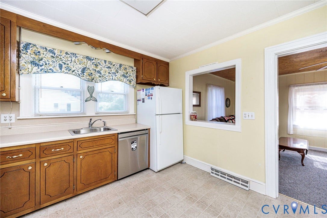 4912 Water View Road, Water View, Jamaica, VA 23180 Warm wood cabinetry, stainless steel dishwasher, dual windows, and a pass-through opening