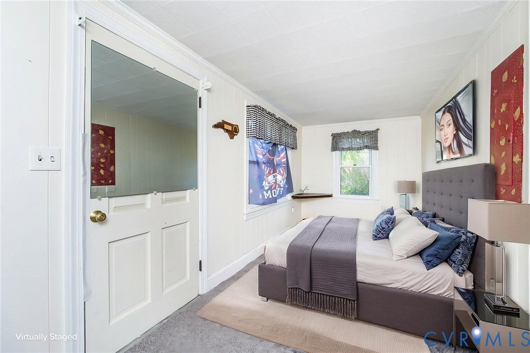 4912 Water View Road, Water View, Jamaica, VA 23180 White paneled walls, a white dutch door with a brass doorknob, and a built-in corner shelf