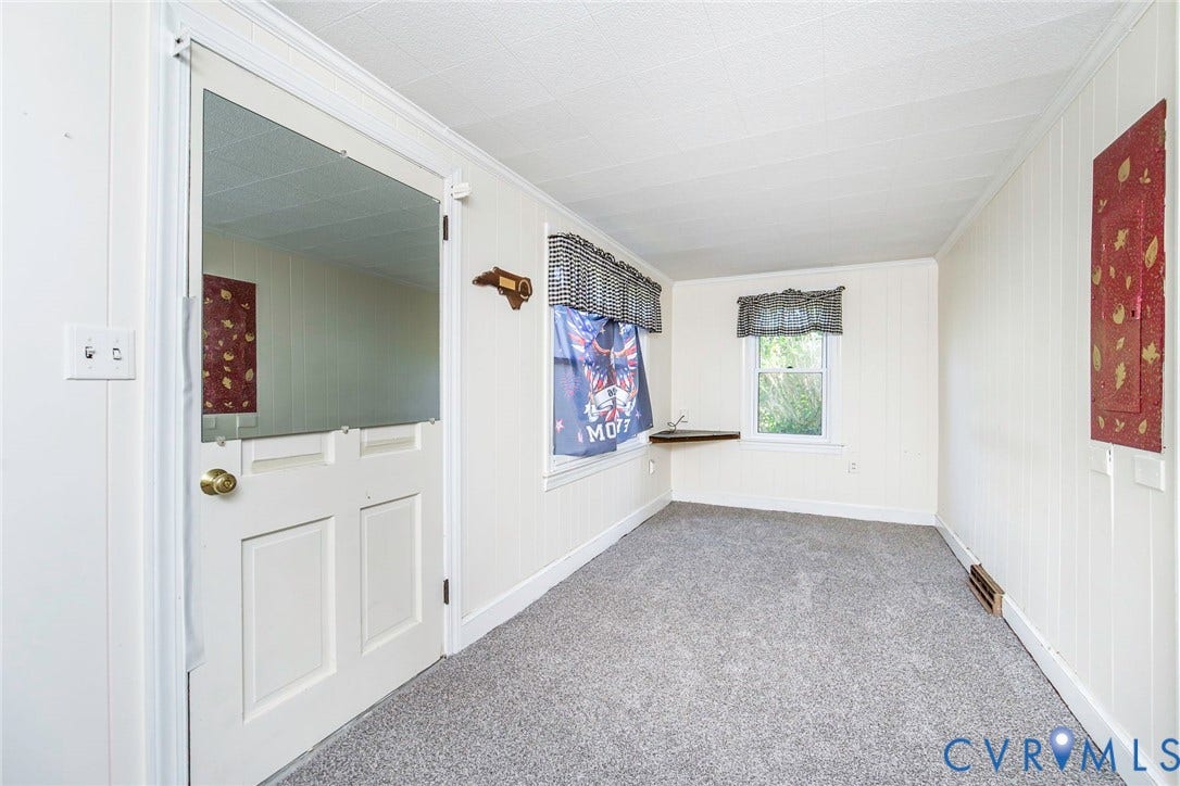 4912 Water View Road, Water View, Jamaica, VA 23180 White paneled walls and ceiling, wall-to-wall carpeting, and a window with a corner-mounted shelf