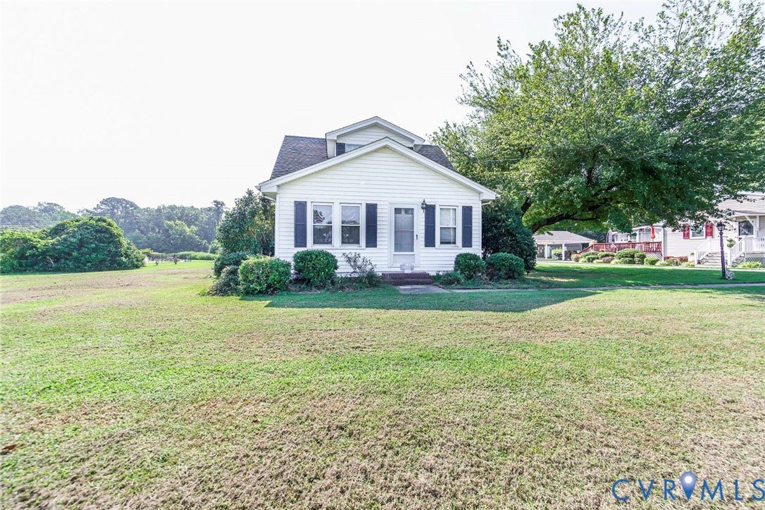 4912 Water View Road, Water View, Jamaica, VA 23180 Expansive land parcel featuring multiple structures, paved driveways, a swimming pool, and mature trees and river
