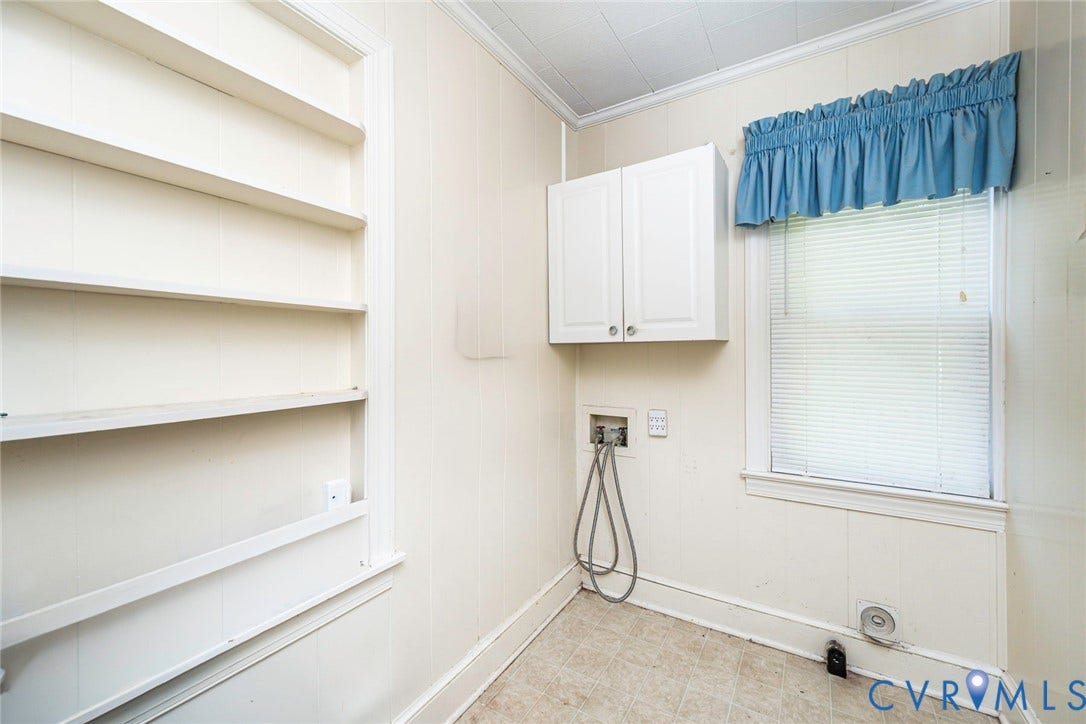 4912 Water View Road, Water View, Jamaica, VA 23180 Built-in shelving, white wall-mounted cabinetry, single window, and paneling
