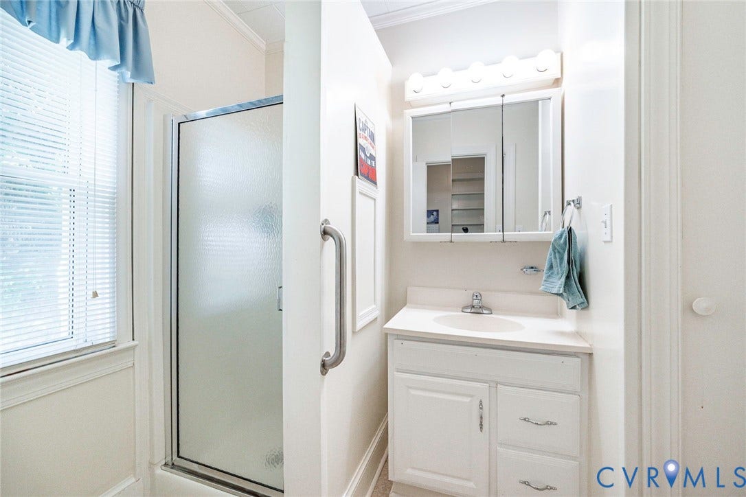 4912 Water View Road, Water View, Jamaica, VA 23180 White vanity with integrated sink, chrome faucet, and mirrored medicine cabinet