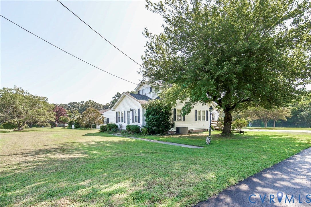 4912 Water View Road, Water View, Jamaica, VA 23180 Expansive lot featuring a detached residence with white siding, dark shutters, and a sloped roof