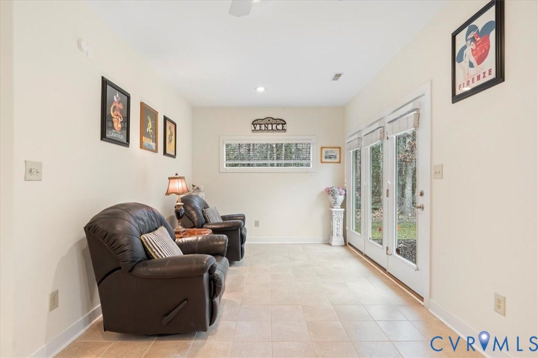 8908 Thomas Higgs Court, Toano, VA 23168 Light-toned tile flooring, white walls, and a white ceiling create a bright interior