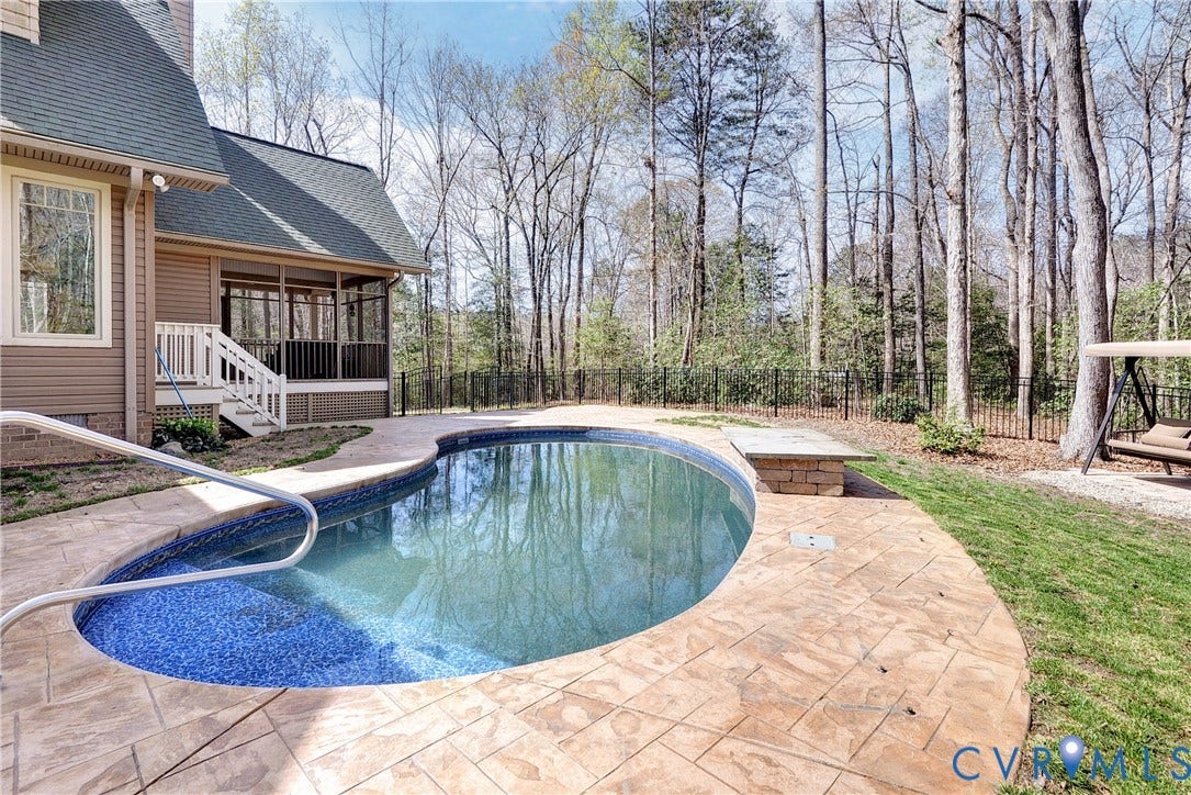 8908 Thomas Higgs Court, Toano, VA 23168 swimming pool with patterned tile interior, stamped concrete surround, and a screened porch