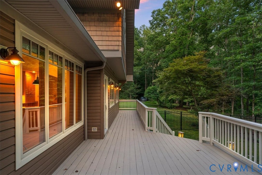 8908 Thomas Higgs Court, Toano, VA 23168 Expansive outdoor deck with composite decking, white railing, exterior wall lighting, and expensive wrap around outer deck.