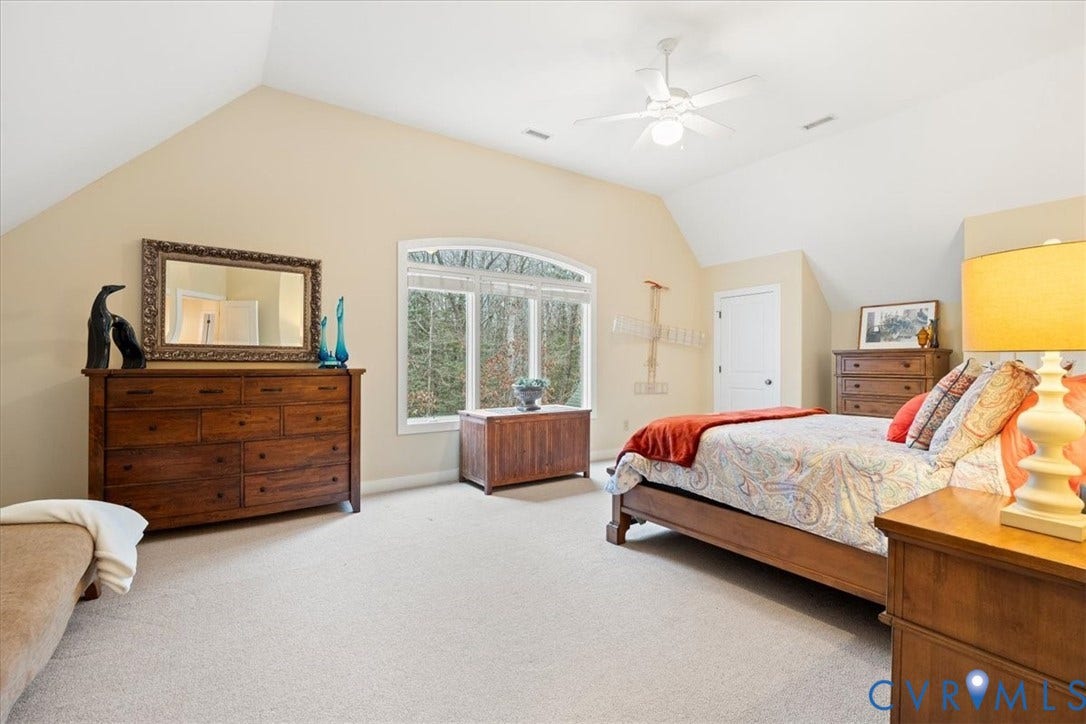 8908 Thomas Higgs Court, Toano, VA 23168 Vaulted ceiling with ceiling fan, arched window, and neutral carpeting