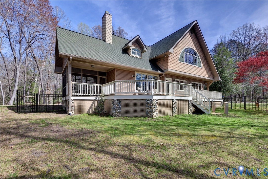 8908 Thomas Higgs Court, Toano, VA 23168 Multi-level exterior deck with a screened porch, lattice skirting, and stone column accents