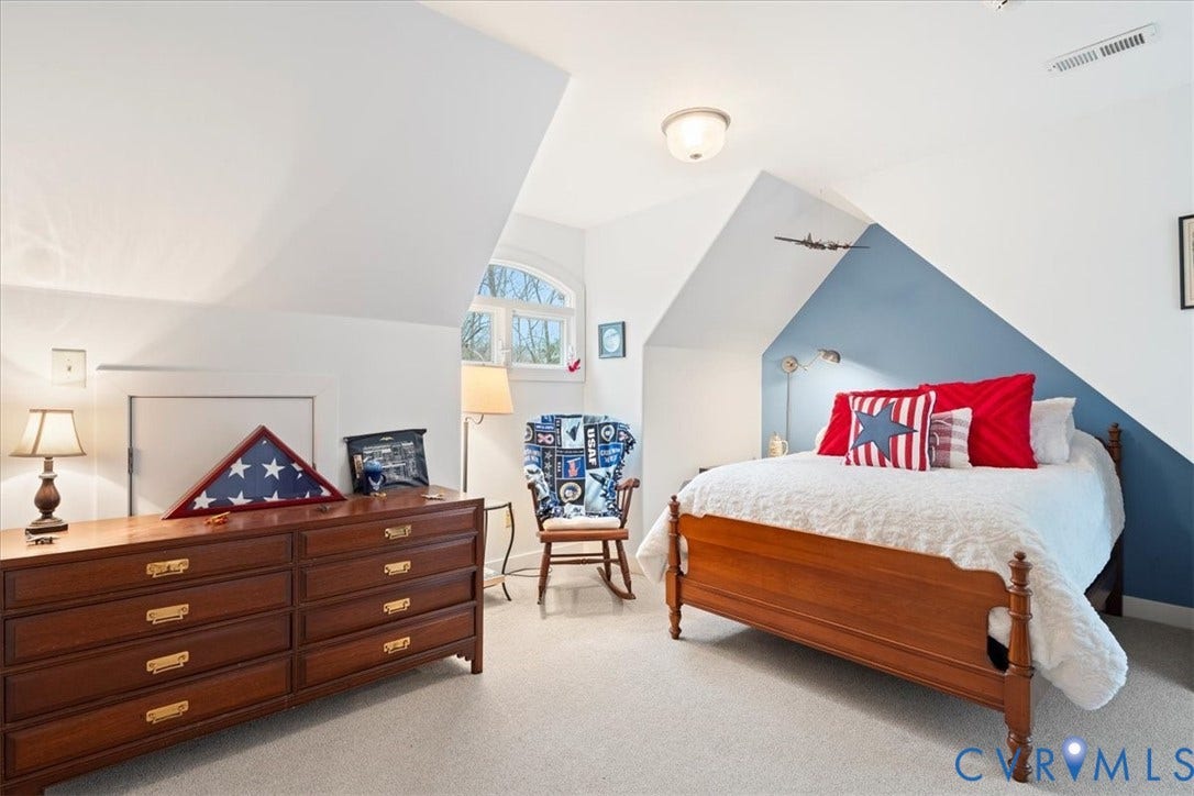 8908 Thomas Higgs Court, Toano, VA 23168 Sloped ceiling architecture, arched window, wall-mounted light fixtures, built-in storage access panel, and wood-finish flooring