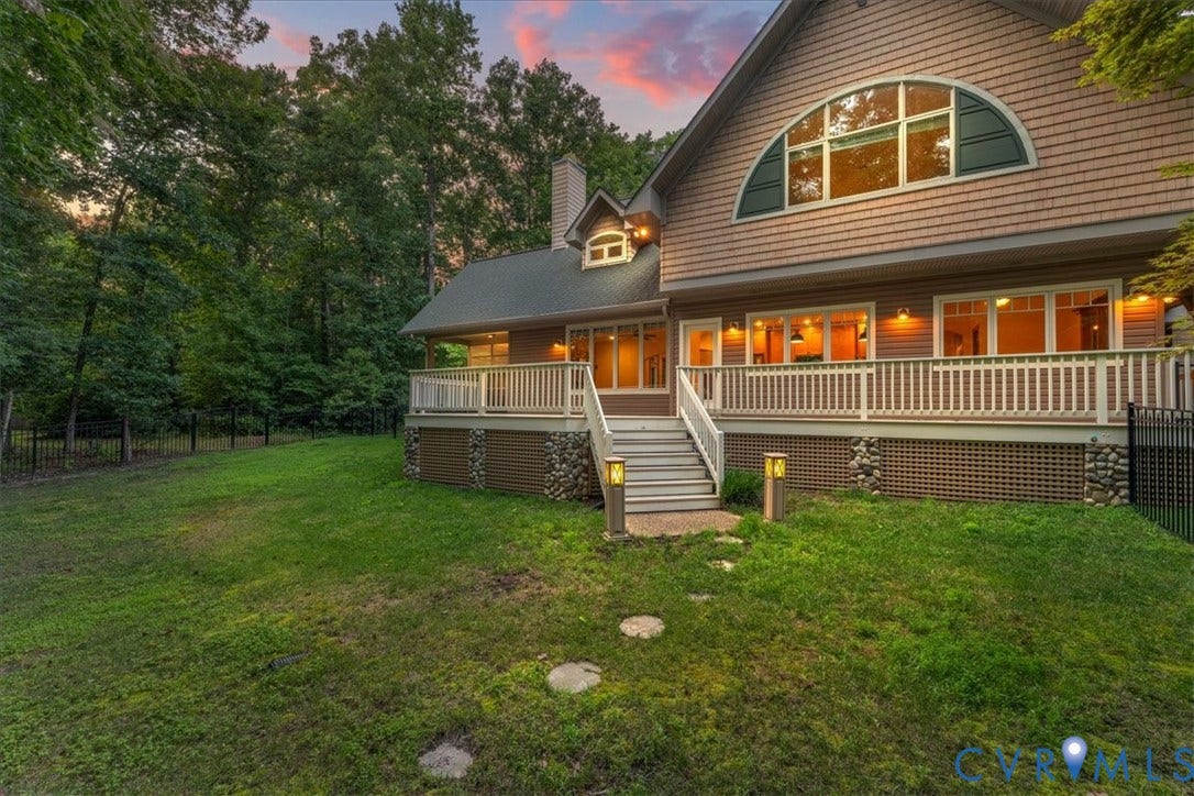 8908 Thomas Higgs Court, Toano, VA 23168 Expansive outdoor deck with composite decking, white railing, exterior wall lighting, and expensive wrap around outer deck.