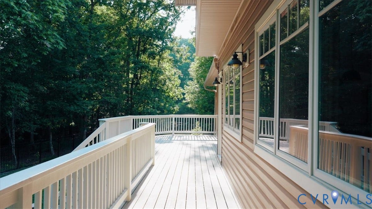 8908 Thomas Higgs Court, Toano, VA 23168 Expansive outdoor deck with a white railing system, featuring a light wood-finish surface