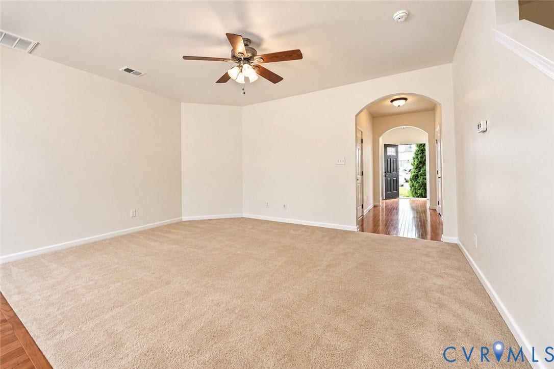 Spacious interior with neutral wall tones and carpet flooring
