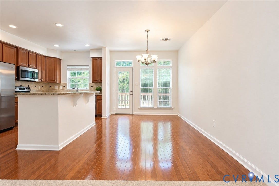 Open-concept living space with wood-finish flooring