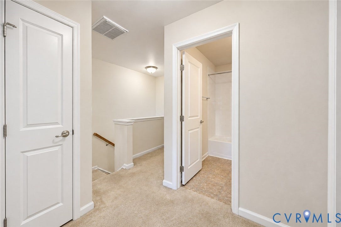 Neutral paint finishes, plush carpeting, white interior doors with satin nickel hardware, and a fully tiled shower with tub