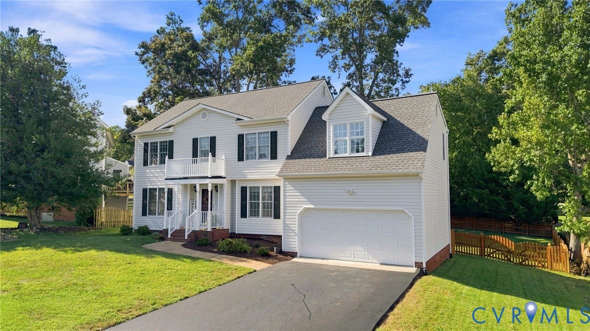11342 McCauliff Court, North Chesterfield, VA 23236 White siding exterior with black shutters, attached two-car garage, upper-level balcony, and a paved driveway