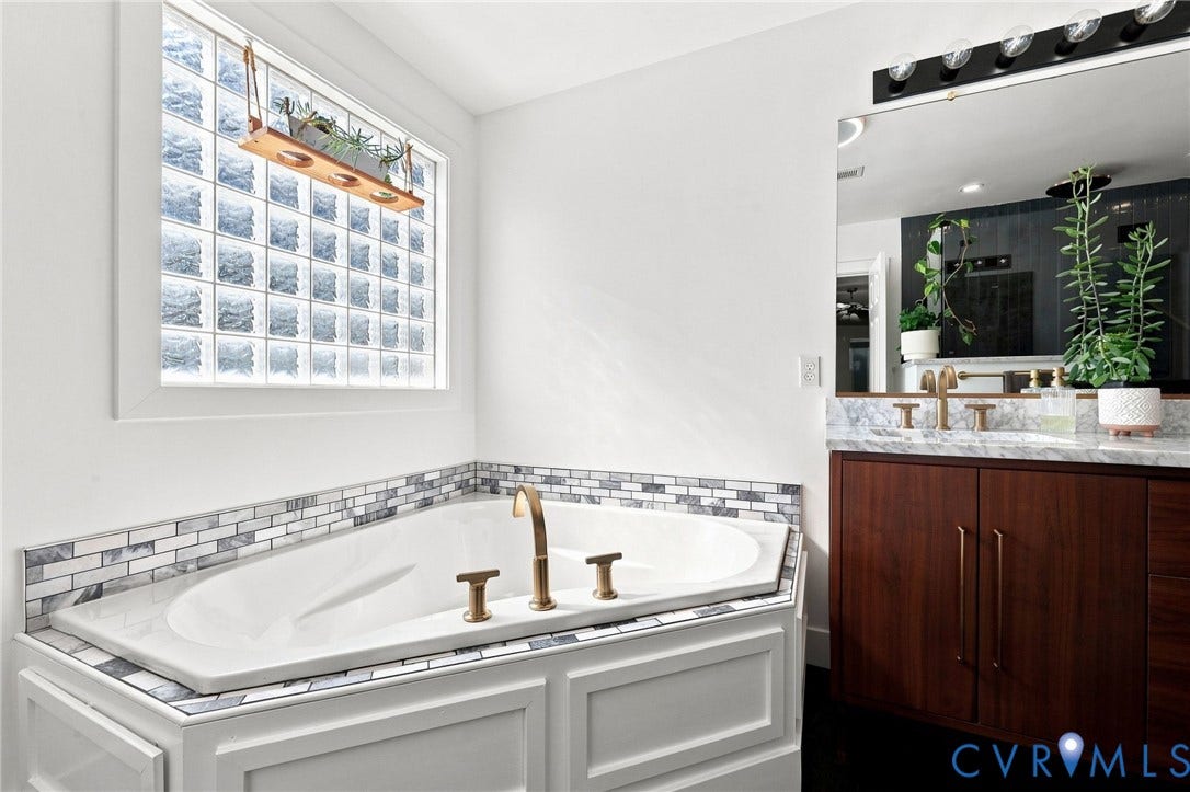 11342 McCauliff Court, North Chesterfield, VA 23236 Built-in bathtub with subway tile surround, brass-finish fixtures, and glass block window