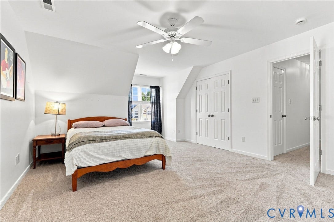 11342 McCauliff Court, North Chesterfield, VA 23236 Spacious bedroom #2 featuring sloped ceilings, a window with dark curtains, light-colored carpeting, a ceiling fan, and white paneled doors