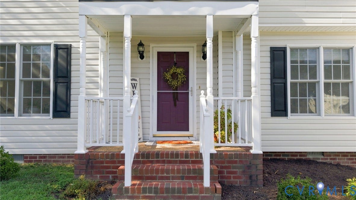 11342 McCauliff Court, North Chesterfield, VA 23236 Front entry with a portico, brick steps, white railings, and a bold front door