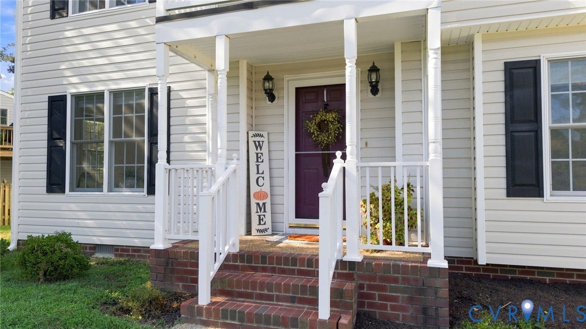 11342 McCauliff Court, North Chesterfield, VA 23236 Inviting front porch featuring white columns and railings, brick steps, and a bold front door