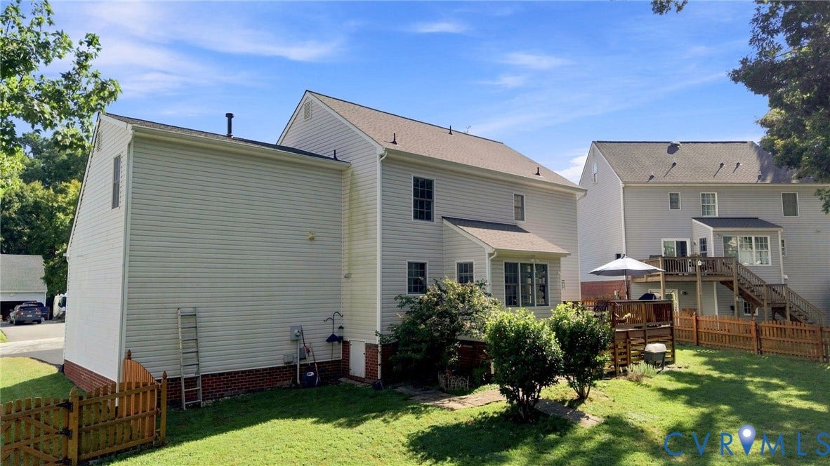 11342 McCauliff Court, North Chesterfield, VA 23236 Expansive backyard featuring a manicured lawn, established landscaping, and wood fencing