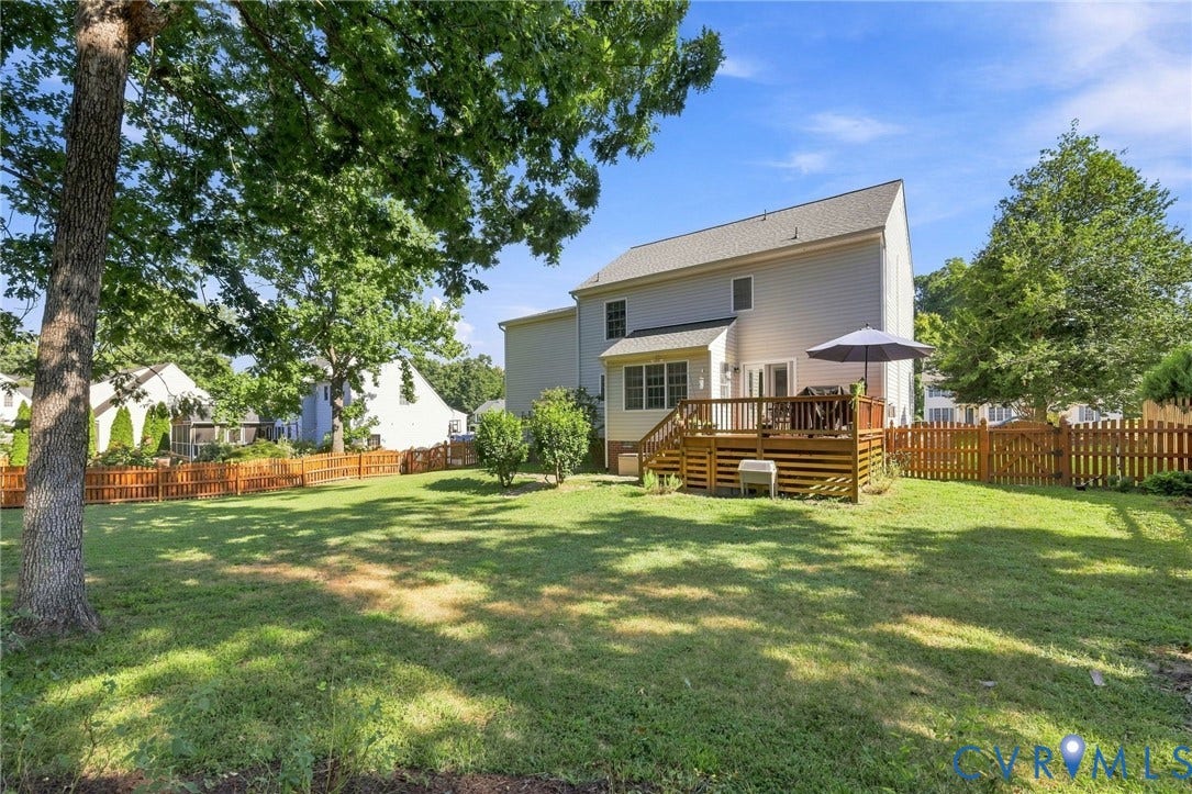 11342 McCauliff Court, North Chesterfield, VA 23236 Expansive backyard featuring a manicured lawn, a full wooden privacy fence, and mature trees