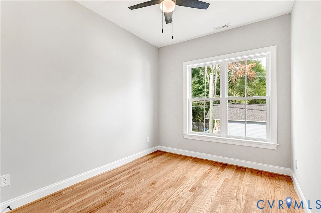 310 E 33rd Street, Swansboro West, Richmond, VA 23224 Hardwood flooring, white wall paint, white trim, ceiling fan, and a double-hung window