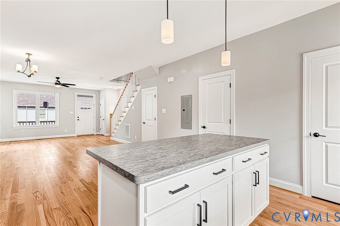310 E 33rd Street, Swansboro West, Richmond, VA 23224 Kitchen island with a light-toned countertop and white cabinetry