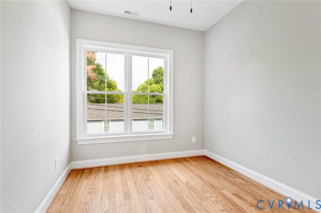 310 E 33rd Street, Swansboro West, Richmond, VA 23224 Hardwood flooring, painted walls, white trim, and a double-hung window
