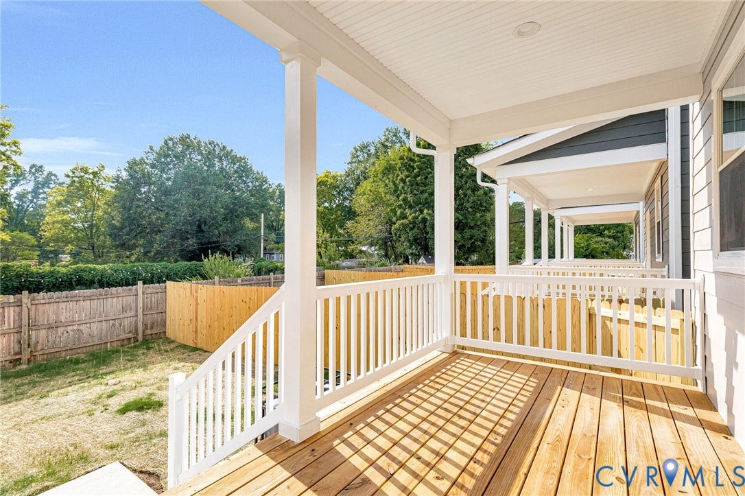 310 E 33rd Street, Swansboro West, Richmond, VA 23224 Expansive wood deck with white railings and columns, featuring a white beadboard ceiling with recessed lighting