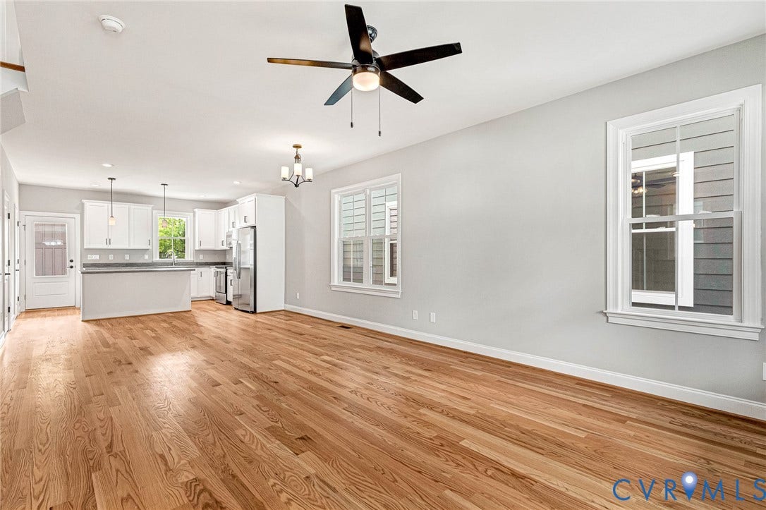 310 E 33rd Street, Swansboro West, Richmond, VA 23224 Spacious open-concept living area showcasing hardwood flooring, recessed ceiling lighting, and a ceiling fan with wood and black metal accents