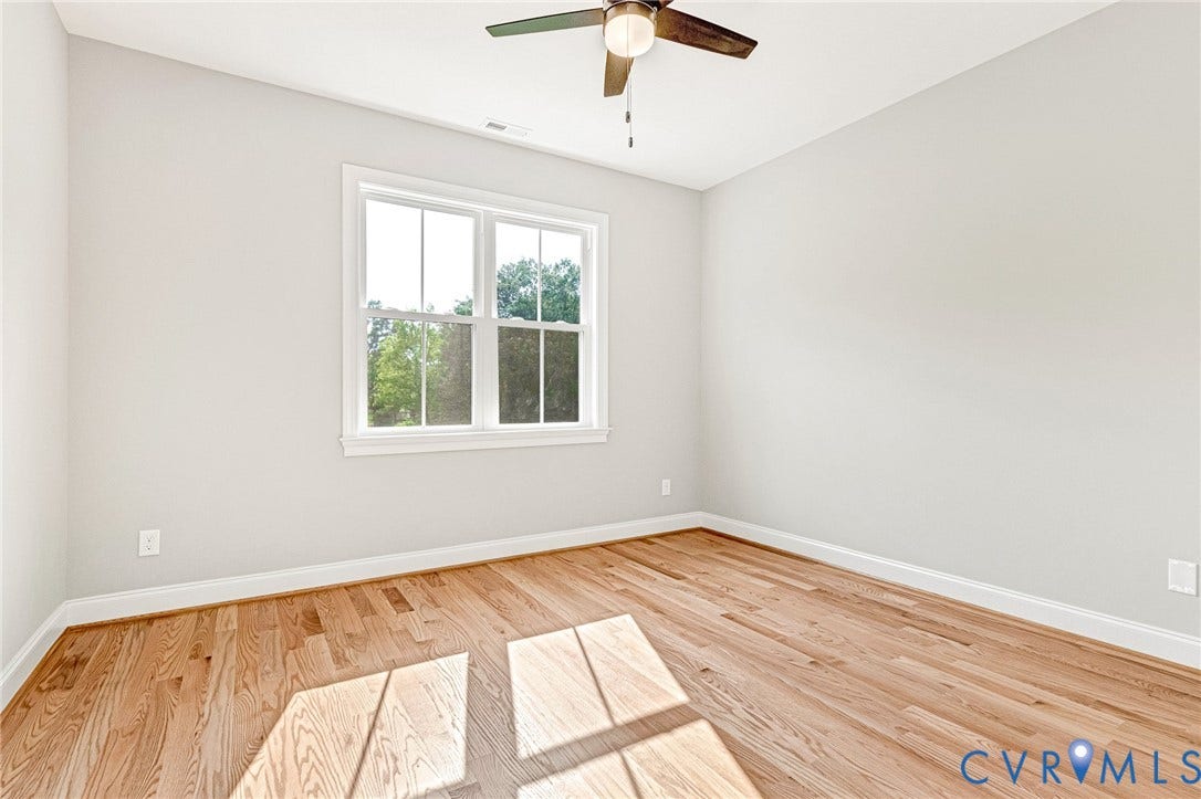 310 E 33rd Street, Swansboro West, Richmond, VA 23224 Wood-finish flooring, white trim, a double-hung window, and a ceiling fan