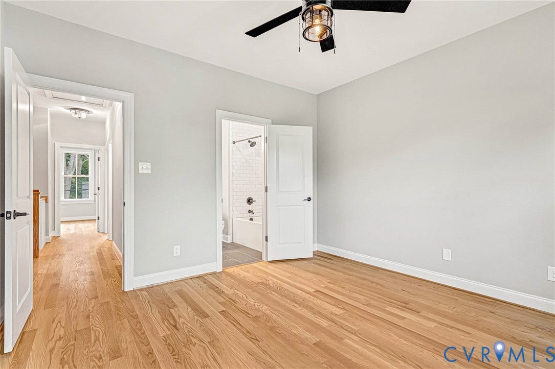 308 E 33rd Street, Swansboro West, Richmond, VA 23224 Hardwood flooring, light gray wall finishes, a modern ceiling fan, and a white paneled door