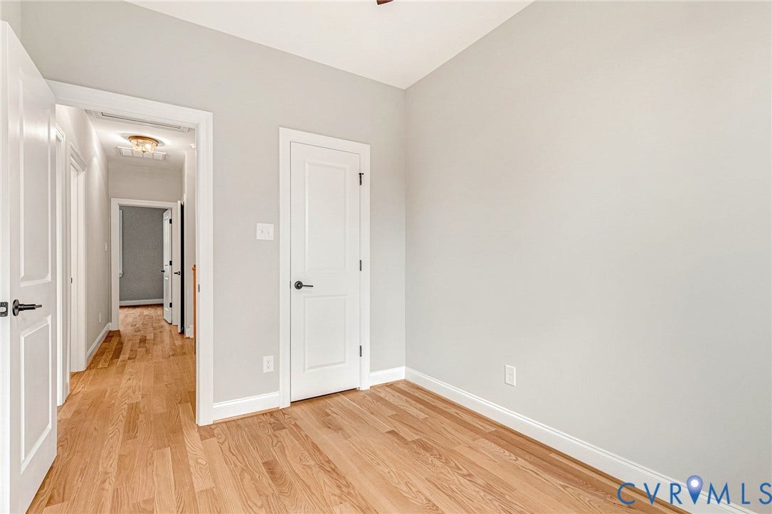 308 E 33rd Street, Swansboro West, Richmond, VA 23224 Hardwood flooring throughout, neutral wall tones, white trim, and white paneled doors with dark hardware