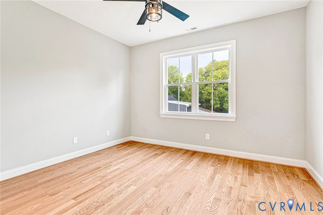 308 E 33rd Street, Swansboro West, Richmond, VA 23224 Hardwood flooring, painted walls, white trim, double-hung window, and a ceiling fan