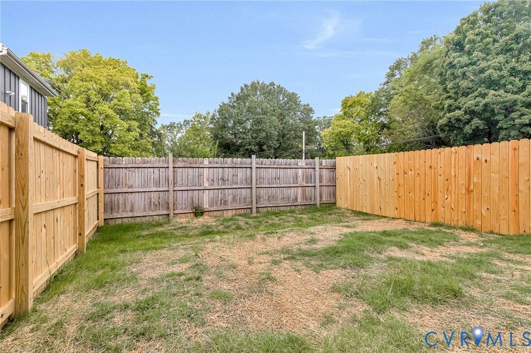 308 E 33rd Street, Swansboro West, Richmond, VA 23224 Expansive outdoor space featuring a new wood fence and established perimeter fencing