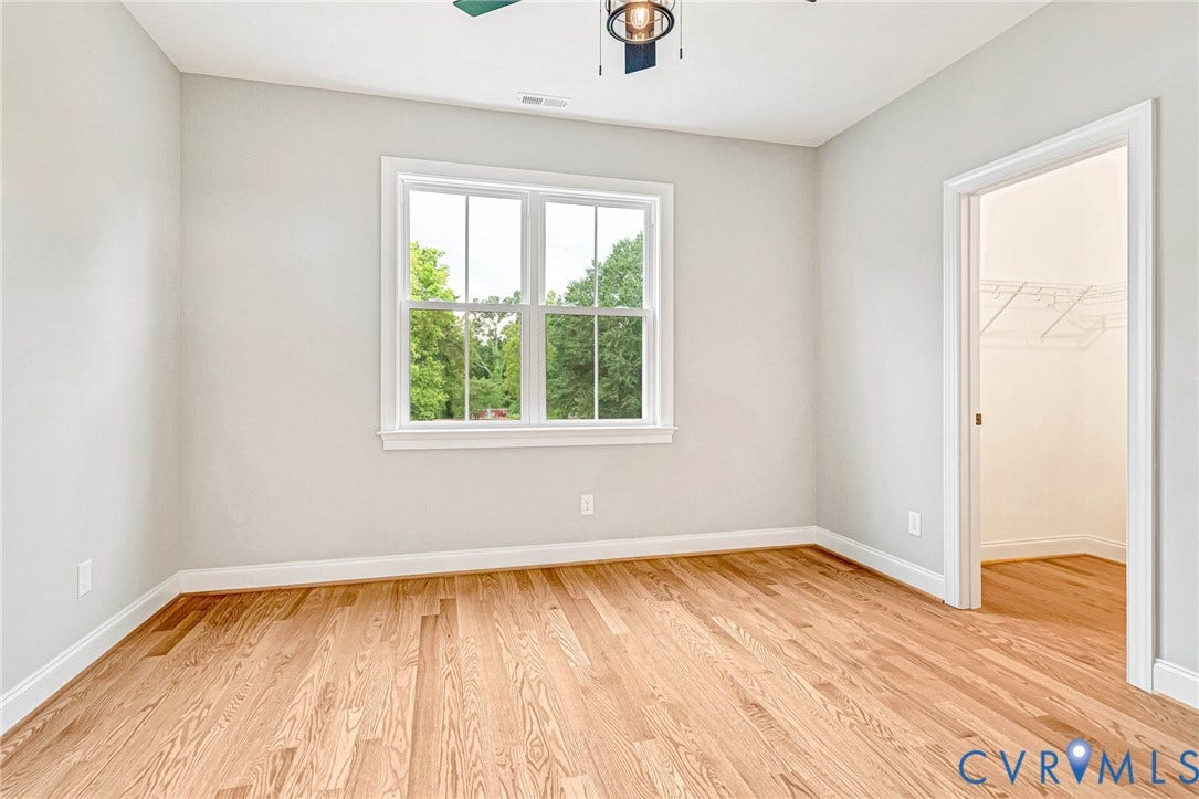 308 E 33rd Street, Swansboro West, Richmond, VA 23224 Hardwood flooring, white trim, window with natural lighting, ceiling light fixture, and closet with wire shelving