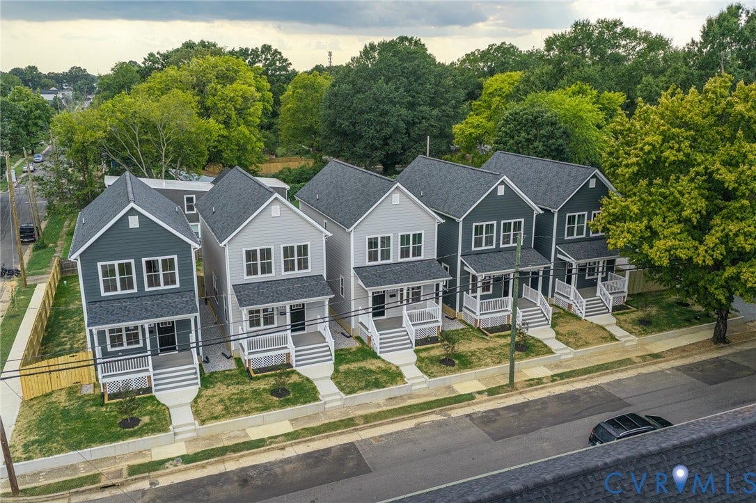 308 E 33rd Street, Swansboro West, Richmond, VA 23224 Newly constructed homes featuring a combination of light and dark siding, gabled roofs, front porches with white railings, and paved sidewalks
