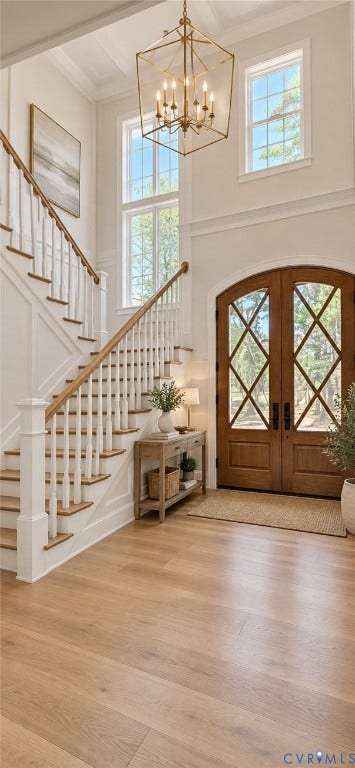 2695 High Bank Place, Powhatan, VA 23139 Hardwood flooring, wood-paneled staircase with white balusters, arched double entry doors with diamond-patterned glass, transom windows, and a coffered ceiling