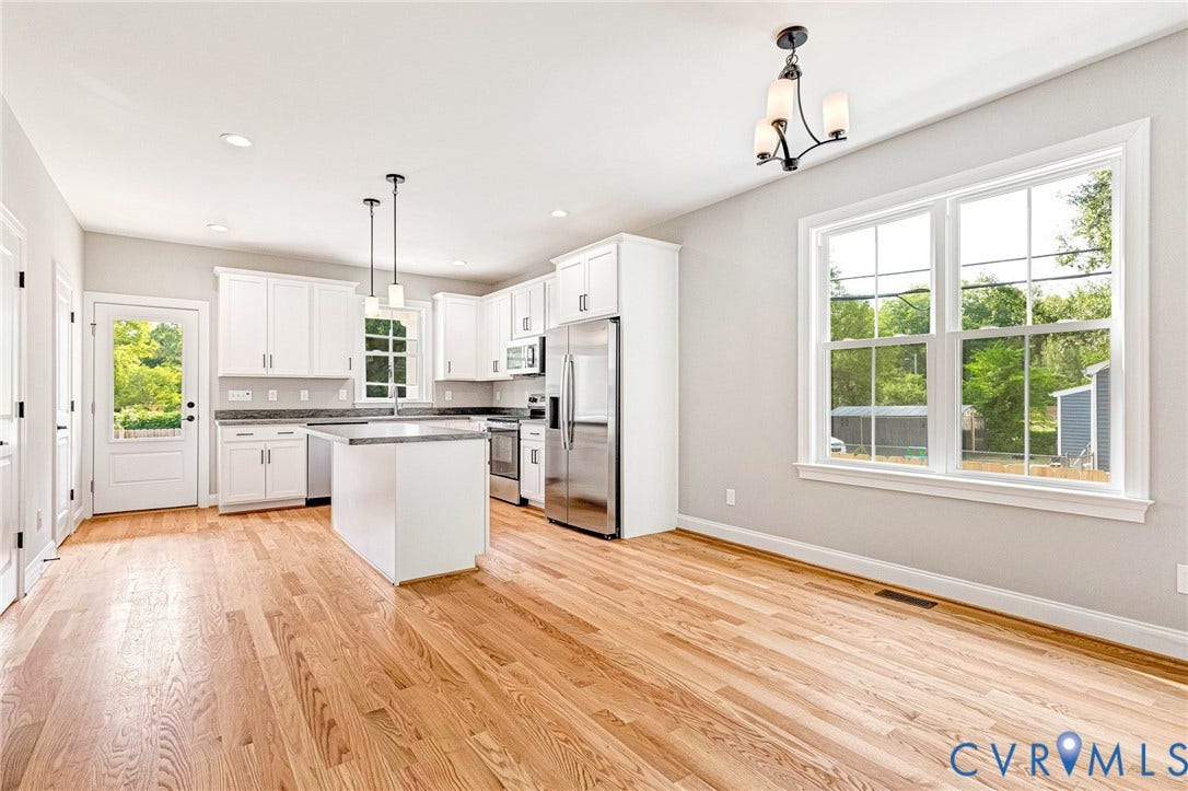 306 E 33rd Street, Swansboro West, Richmond, VA 23224 Open-concept interior featuring light wood flooring, white cabinetry, stainless steel appliances, a kitchen island with pendant lighting, and recessed ceiling lights