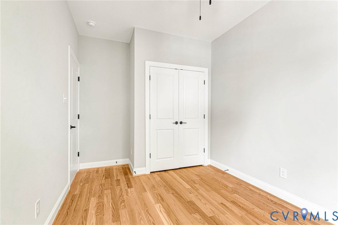 306 E 33rd Street, Swansboro West, Richmond, VA 23224 Hardwood flooring, painted walls, white trim, and white paneled doors