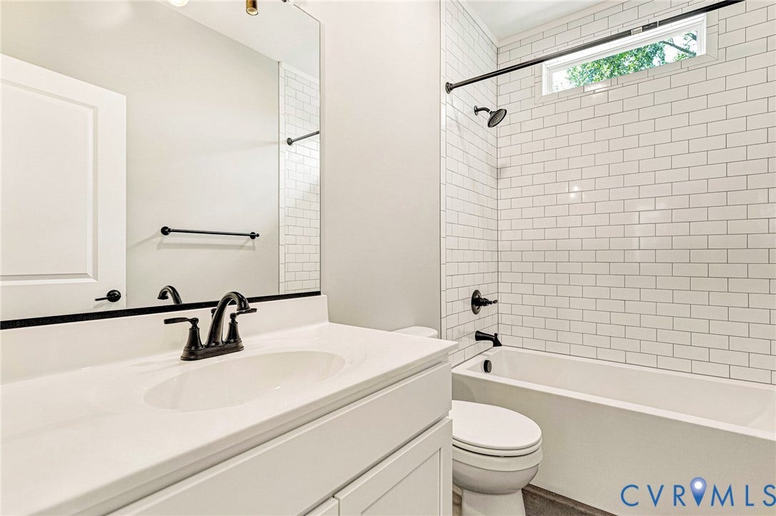 306 E 33rd Street, Swansboro West, Richmond, VA 23224 White subway tile shower surround with a built-in tub and matte black fixtures