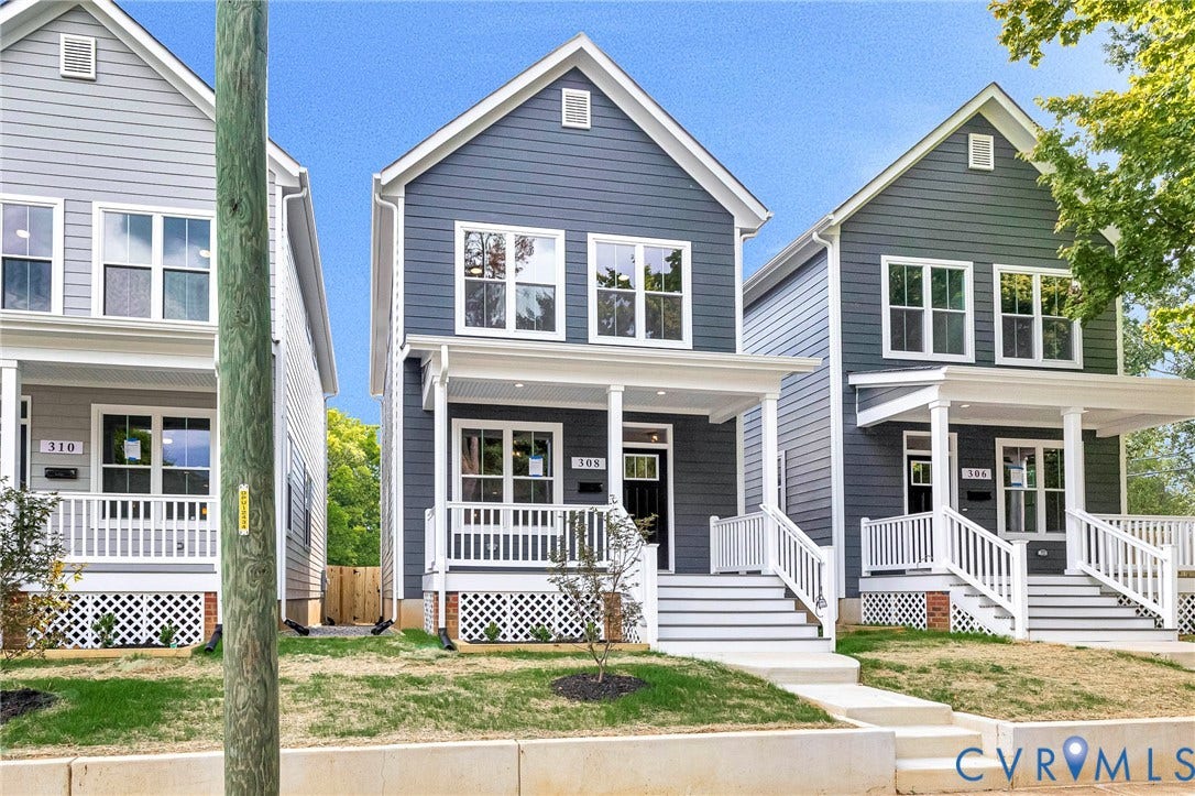 306 E 33rd Street, Swansboro West, Richmond, VA 23224 Contemporary home featuring gray siding, a covered front porch with white railings, and multiple double-hung windows