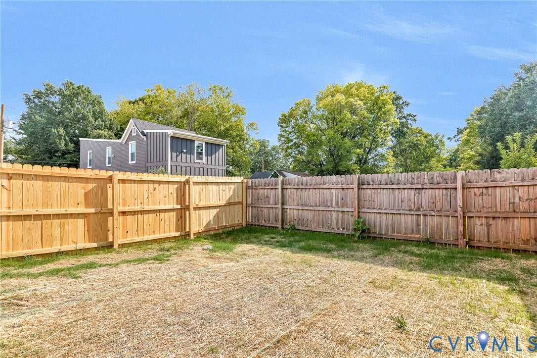 306 E 33rd Street, Swansboro West, Richmond, VA 23224 Fenced backyard with natural wood privacy fencing and ample outdoor space