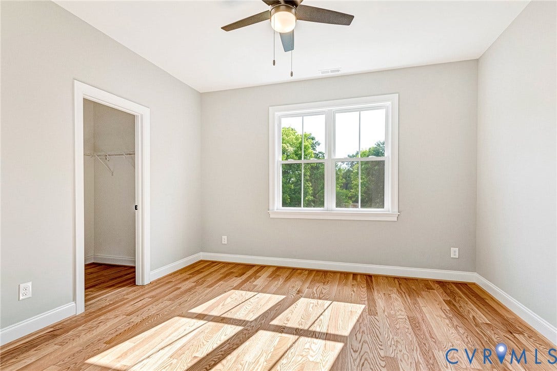 306 E 33rd Street, Swansboro West, Richmond, VA 23224 Hardwood flooring, white trim, recessed closet, ceiling fan, and a large window